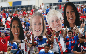 Fans holding the face images of the U.S. players