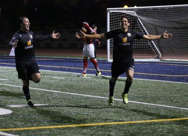 The Men in Black: NC Battalion players Tim Roty and Nelson Pizarro celebrate the final goal in their team's 5-3 NPSL playoff victory over Deportivo Coras on July 9th.